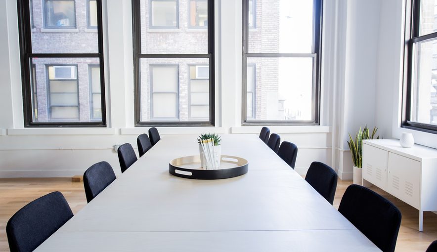 Bright meeting room with a long table and large windows