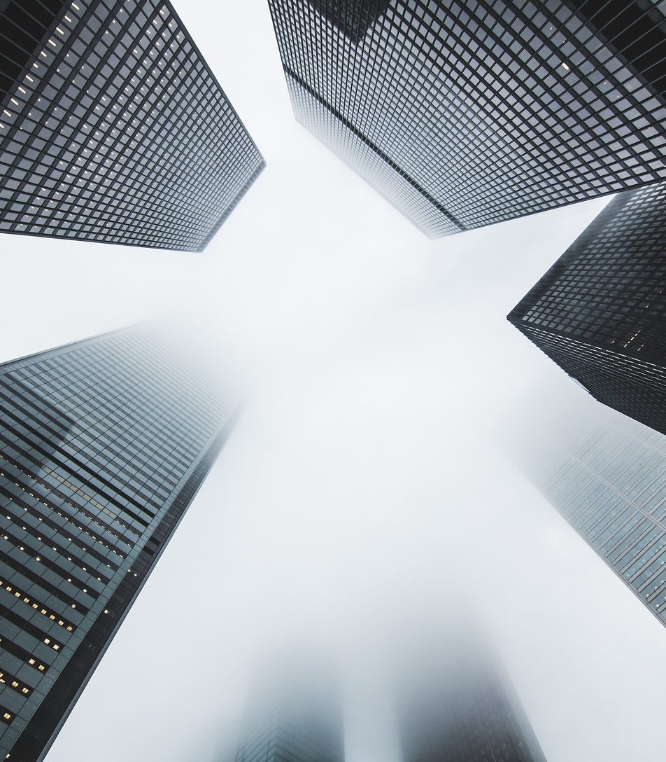 Office towers rising into the morning fog